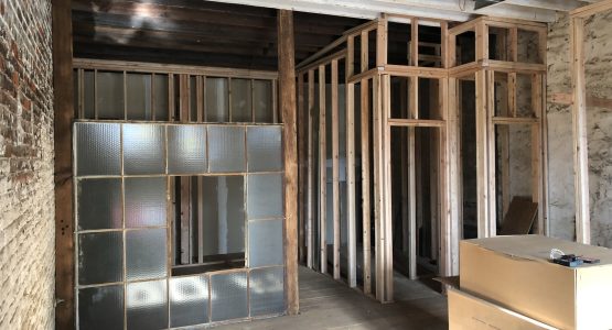 Re-Purposed Factory Window Used as a bedroom wall in a Studio Apartment