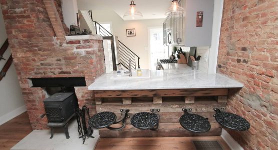 Reclaimed flooring made this bar and the swing-out stools were re-purposed from an old Philadelphia school